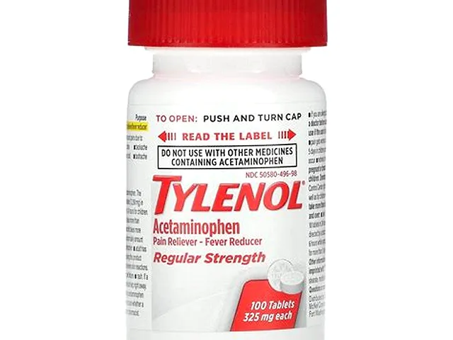 Tylenol acetaminophen tablets and bottle on a clean surface
