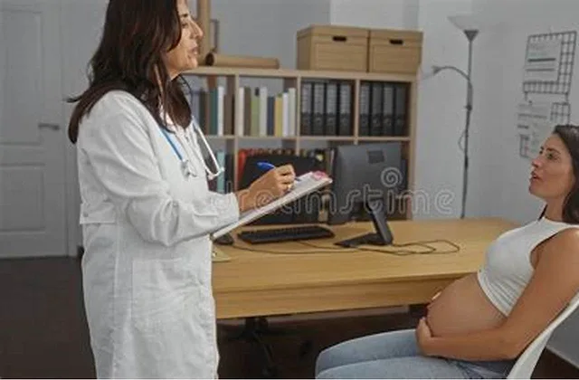 Expectant parent reading a Tylenol acetaminophen label while considering pain relief during pregnancy
