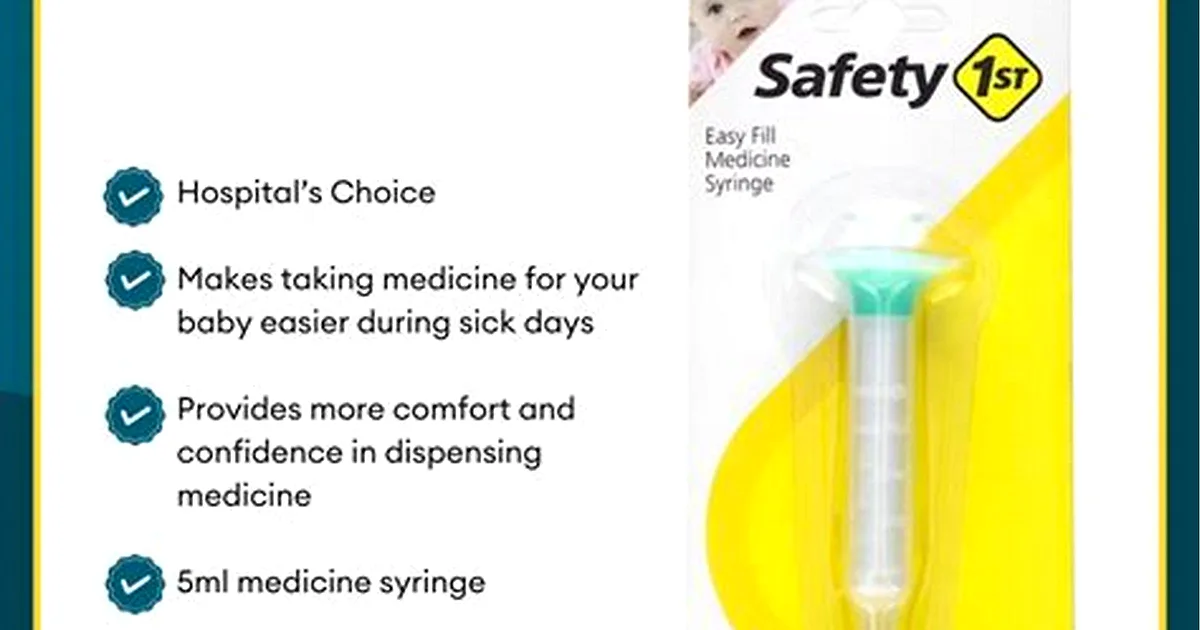 Infant Tylenol oral suspension with an oral syringe next to a resting baby